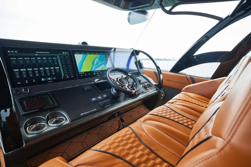 Slide: The Image of 2024 Midnight Express 43 Solstice cockpit with advanced navigation screens and luxurious leather seating. - 15