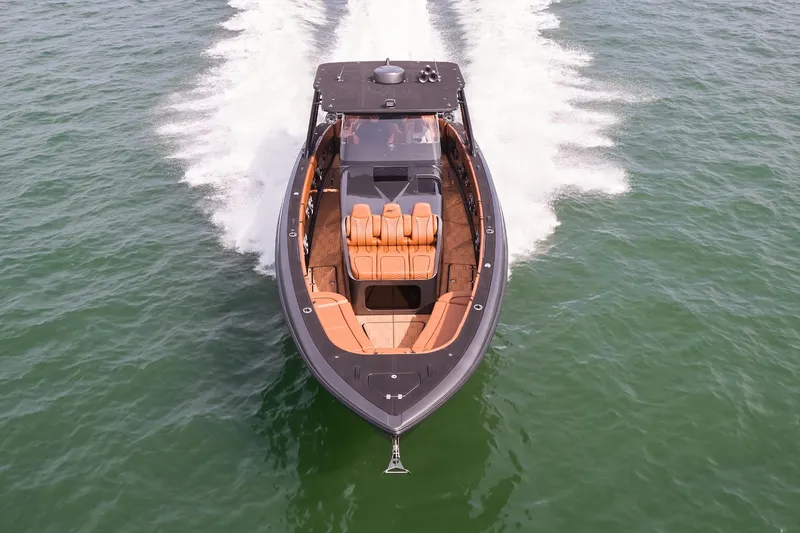 Slide: The Image of 2024 Midnight Express 43 Solstice boat cruising on open water, aerial view. - 2