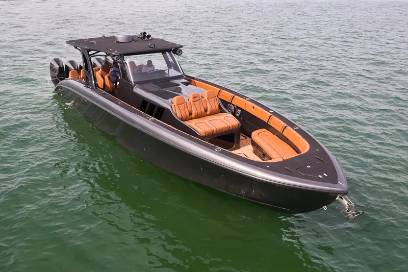 Slide: The Image of 2024 Midnight Express 43 Solstice luxury boat on water, featuring sleek design and orange seating. - 4