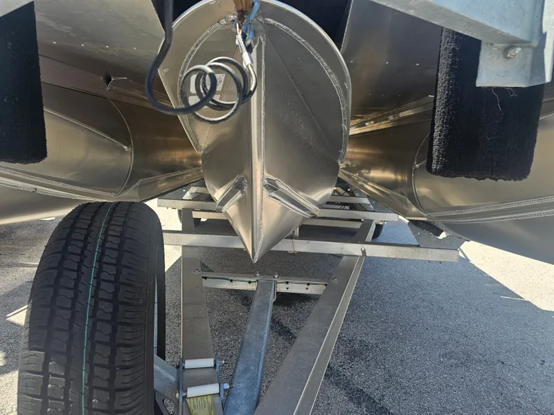 Slide: The Image of Underside of Avalon LSZ 2385 Quad Lounger Tritoon on trailer. - 11