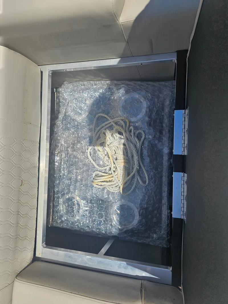 Slide: The Image of Interior of Avalon LSZ 2385 QUAD LOUNGER TRITOON with rope and packaging. - 17