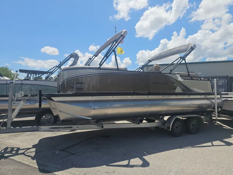 Slide: The Image of 2026 Avalon LSZ 2385 Quad Lounger Tritoon on trailer, blue sky. - 36