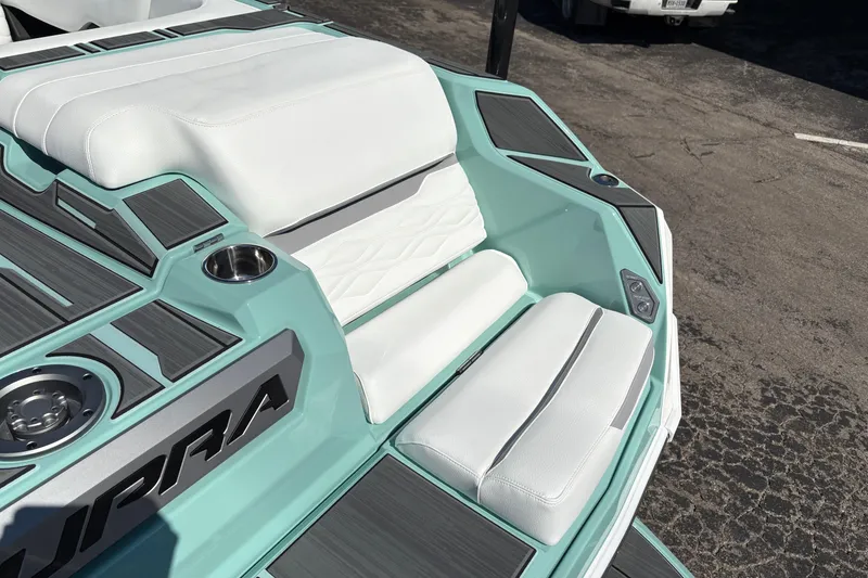 Slide: The Image of 2026 Supra SA 550 boat interior with white seating and teal accents. - 13