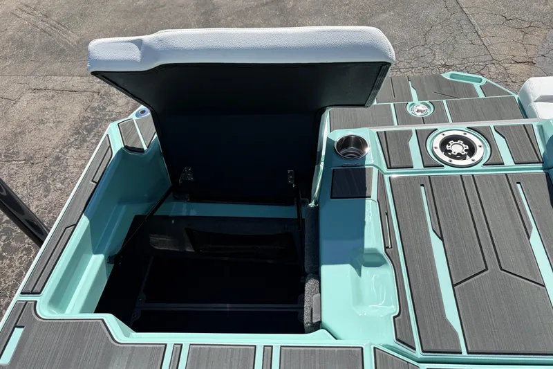 Slide: The Image of Open storage compartment on 2026 Supra SA 550 boat with sleek design and cup holder. - 17