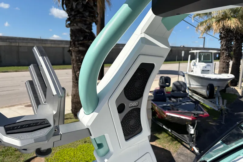 Slide: The Image of 2026 Supra SA 550 boat tower with speakers and wakeboard rack, parked near palm trees. - 19