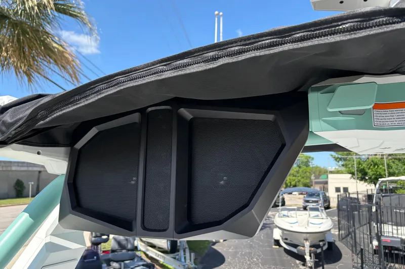 Slide: The Image of 2026 Supra SA 550 boat speakers under canopy, sunny day, palm tree in background. - 20