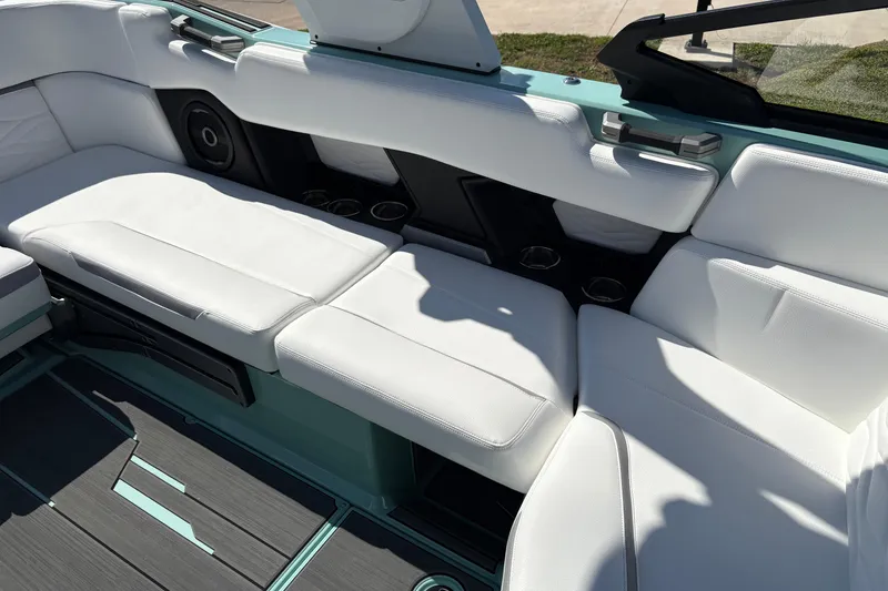 Slide: The Image of 2026 Supra SA 550 boat interior with white seating and cup holders. - 25