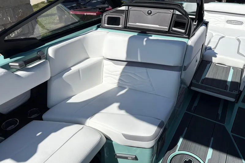 Slide: The Image of 2026 Supra SA 550 boat interior with white seating and teal accents. - 29