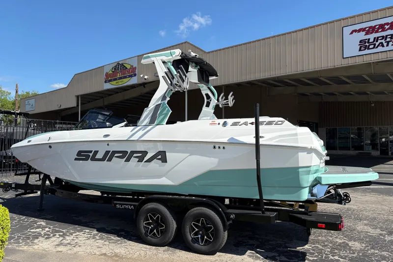 Slide: The Image of 2026 Supra SA 550 boat on trailer outside dealership, showcasing sleek design and modern features. - 5