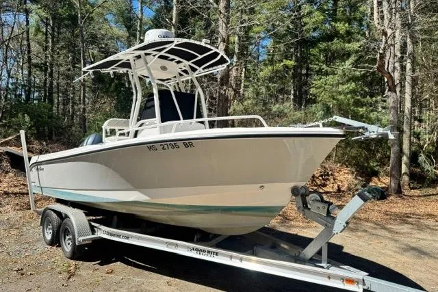 The Image of 2021 Edgewater 208CC boat on trailer in wooded area. - 0