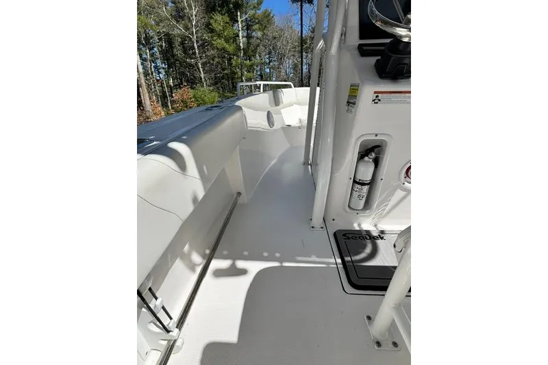 Slide: The Image of 2021 Edgewater 208CC boat interior with white deck and safety equipment. - 11