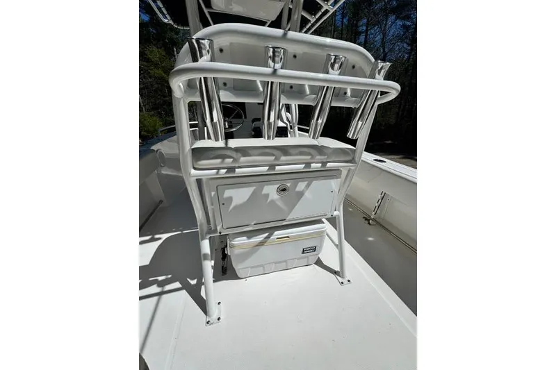 Slide: The Image of 2021 Edgewater 208CC boat interior with rod holders and storage compartment. - 16