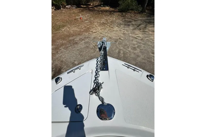 Slide: The Image of Bow view of 2021 Edgewater 208CC boat with anchor chain on deck. - 19