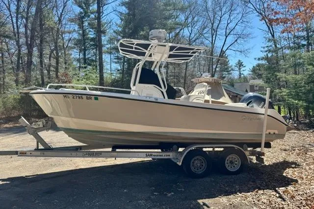 Slide: The Image of 2021 Edgewater 208CC boat on trailer in wooded area, sunny day. - 3