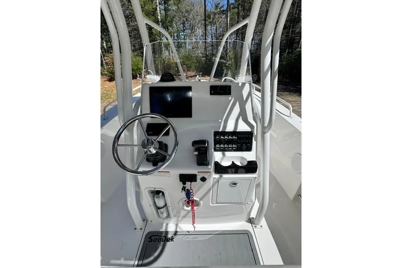 Slide: The Image of 2021 Edgewater 208CC boat console with steering wheel and control panel. - 8