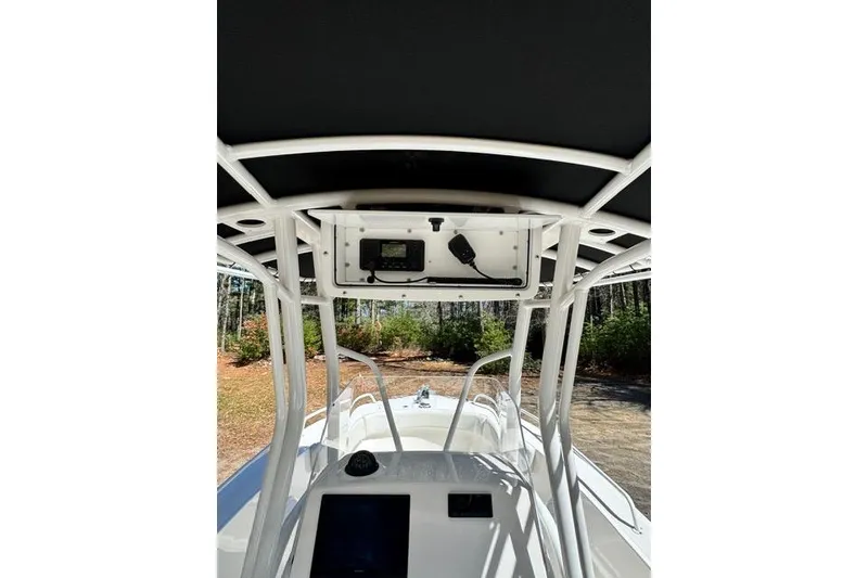 Slide: The Image of 2021 Edgewater 208CC boat console with canopy and electronic equipment. - 9