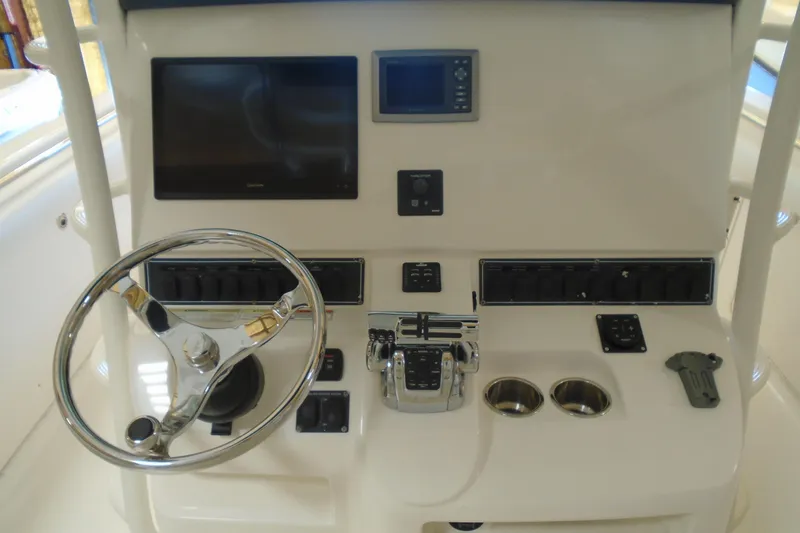 Slide: The Image of Control panel of a 2011 Boston Whaler 330 Outrage boat with steering wheel and electronics. - 13