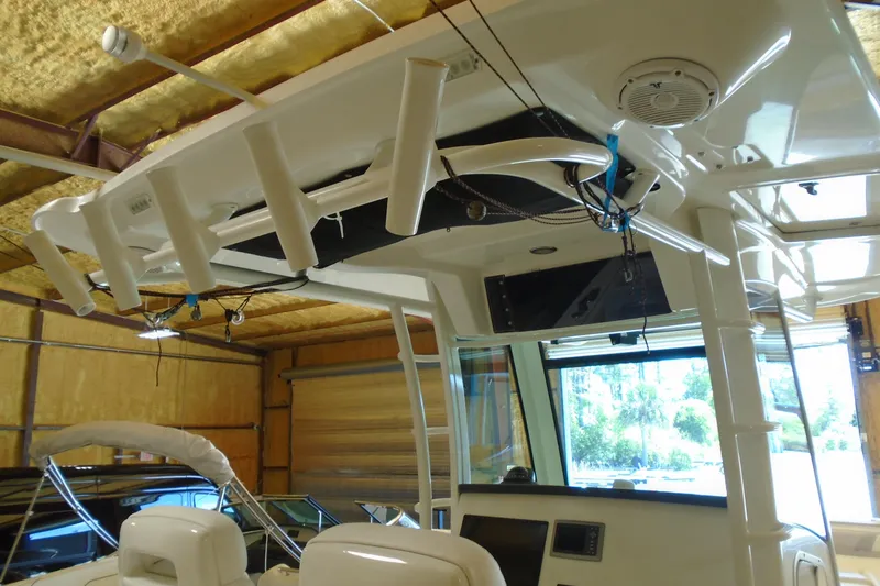Slide: The Image of Interior view of a 2011 Boston Whaler 330 Outrage boat in a garage. - 14