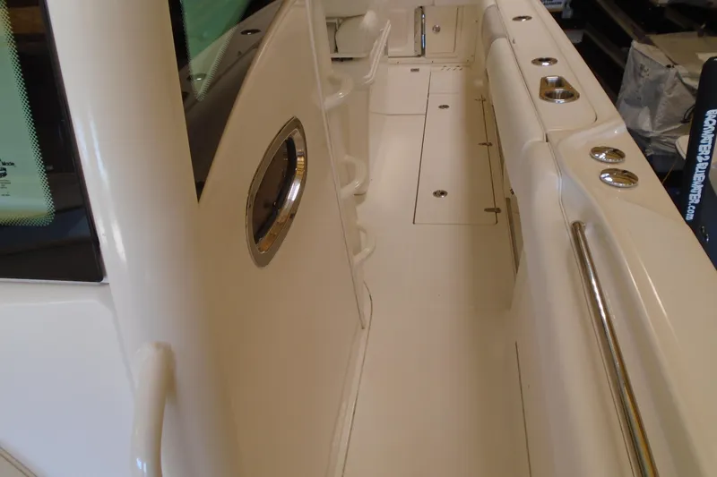 Slide: The Image of 2011 Boston Whaler 330 Outrage boat interior with sleek white deck and stainless steel fittings. - 19