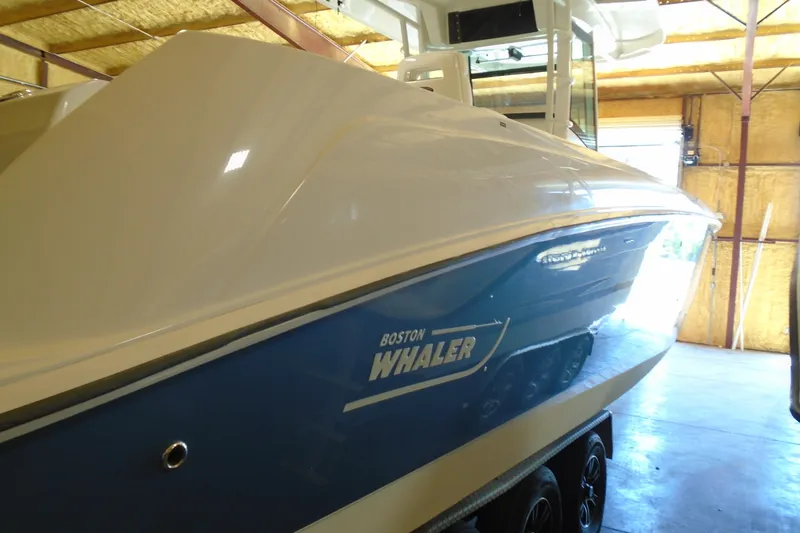Slide: The Image of 2011 Boston Whaler 330 Outrage boat in a garage, side view. - 24
