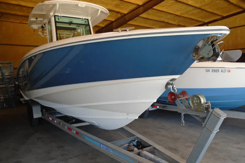 Slide: The Image of 2011 Boston Whaler 330 Outrage boat on trailer in storage facility. - 27