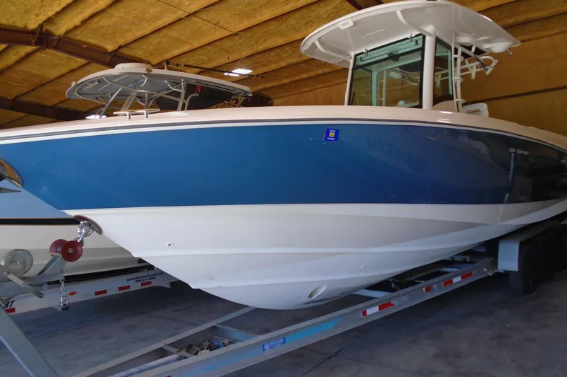 Slide: The Image of 2011 Boston Whaler 330 Outrage boat on trailer in indoor storage. - 28
