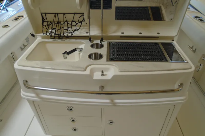 Slide: The Image of 2011 Boston Whaler 330 Outrage boat sink and grill station with storage drawers. - 8