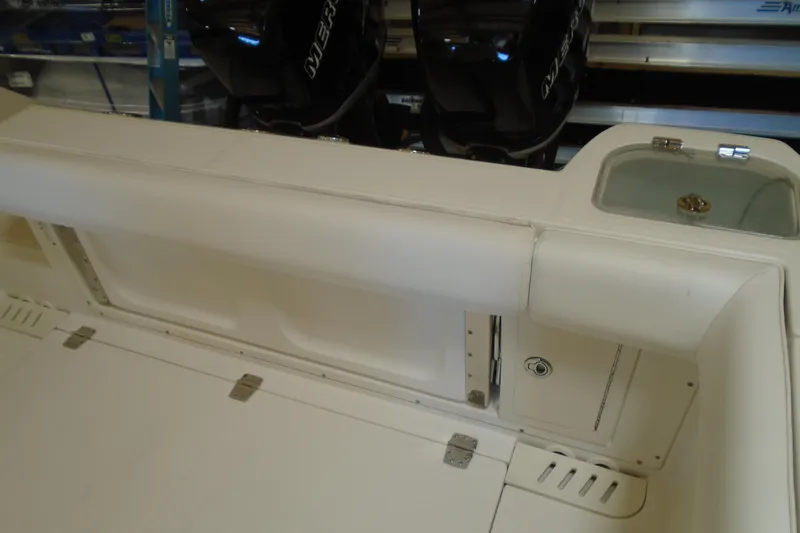 Slide: The Image of 2011 Boston Whaler 330 Outrage boat interior with seating and storage compartments. - 9