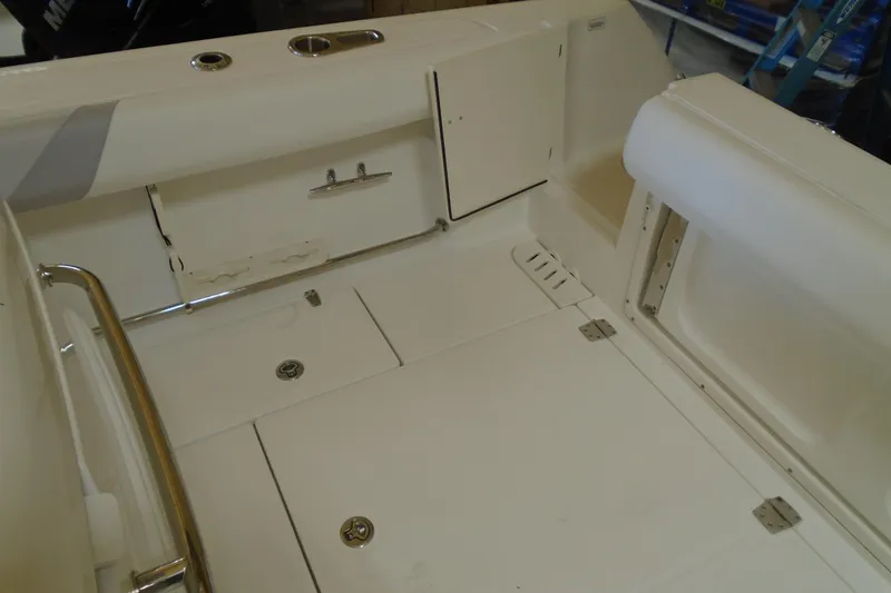 Slide: The Image of 2011 Boston Whaler 330 Outrage boat interior with storage compartments and seating. - 10