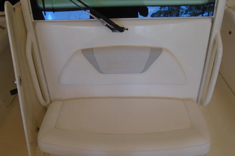 Slide: The Image of Boston Whaler 330 Outrage 2011 boat seat with white cushioned upholstery. - 18