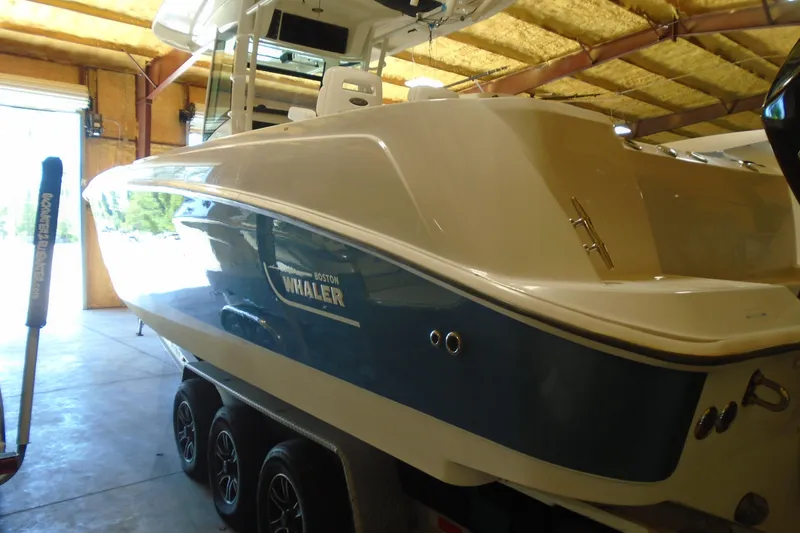 Slide: The Image of 2011 Boston Whaler 330 Outrage boat in a garage, side view. - 23