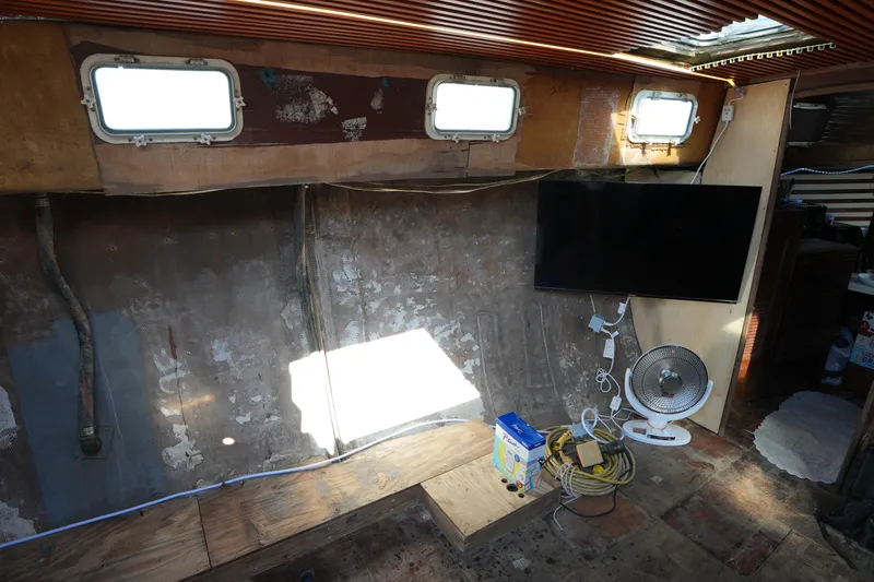 Slide: The Image of Interior of 1990 Endeavour 43 Center Cockpit with TV, fan, and portholes. - 11