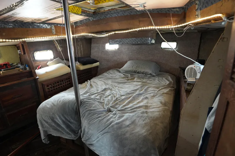 Slide: The Image of Cozy cabin interior of 1990 Endeavour 43 Center Cockpit sailboat with bed and portholes. - 13
