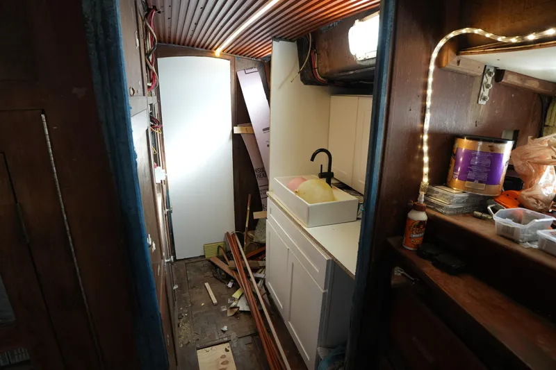 Slide: The Image of Interior renovation of 1990 Endeavour 43 Center Cockpit sailboat with sink and tools. - 14