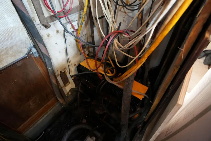 Slide: The Image of Engine compartment of a 1990 Endeavour 43 Center Cockpit with visible wiring and components. - 15