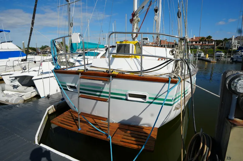 Slide: The Image of 1990 Endeavour 43 Center Cockpit sailboat docked at marina under clear blue sky. - 2
