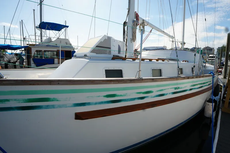 Slide: The Image of 1990 Endeavour 43 Center Cockpit sailboat docked at marina, side view. - 3