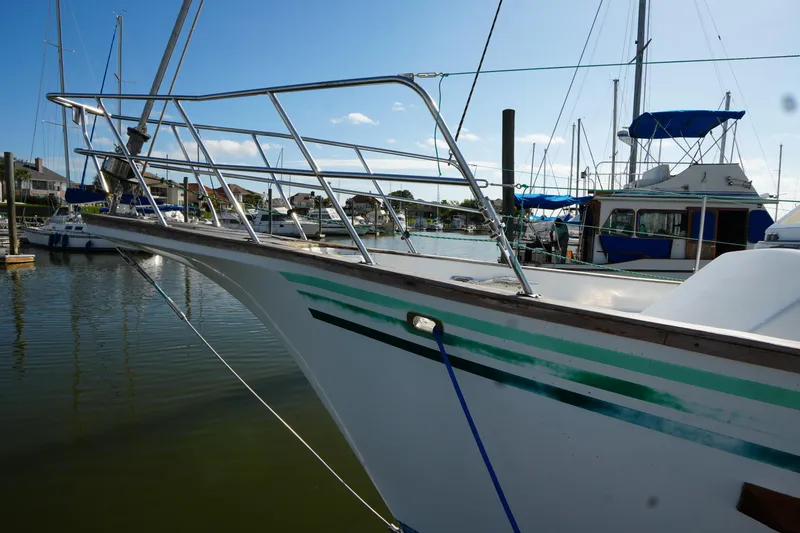 Slide: The Image of 1990 Endeavour 43 Center Cockpit sailboat docked in a marina under clear blue skies. - 4
