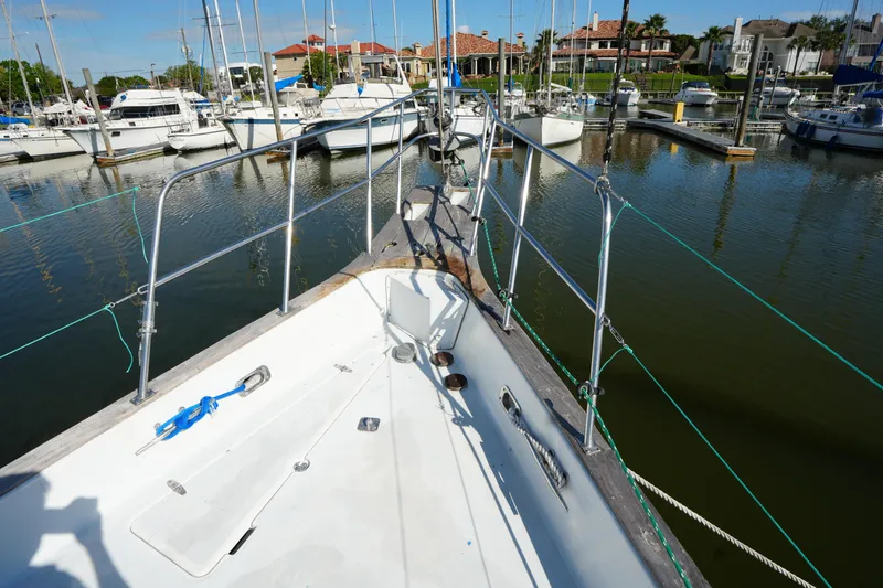 Slide: The Image of 1990 Endeavour 43 Center Cockpit sailboat docked in a marina with other boats. - 5