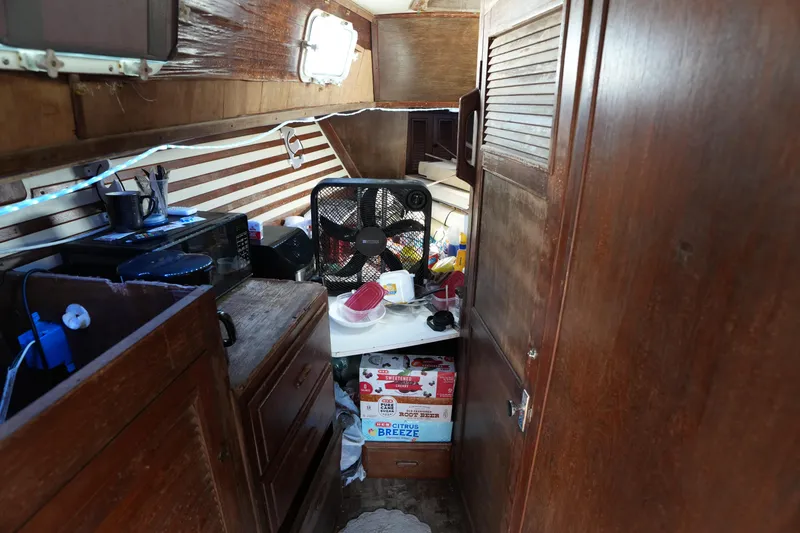 Slide: The Image of Interior of 1990 Endeavour 43 Center Cockpit sailboat with wooden cabinetry and appliances. - 8