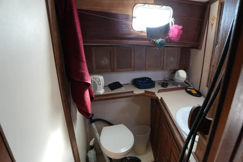 Slide: The Image of Bathroom interior of 1990 Endeavour 43 Center Cockpit yacht with wooden cabinetry. - 9