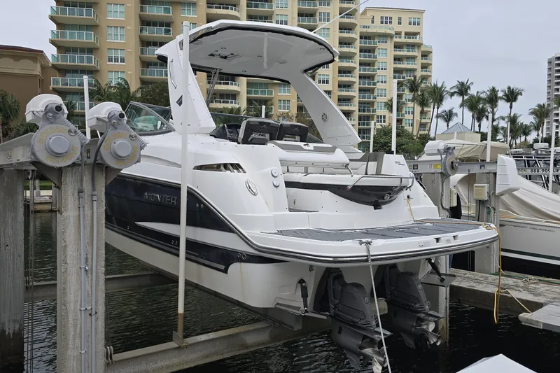 Slide: The Image of 2017 Monterey 355 Sport Yacht docked at marina with modern buildings in background. - 13