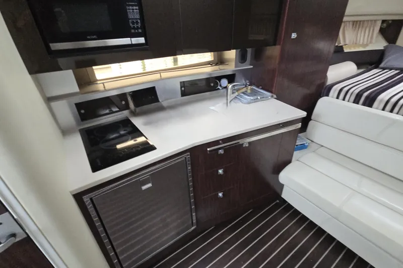 Slide: The Image of Interior of 2017 Monterey 355 Sport Yacht with kitchenette and seating area. - 16