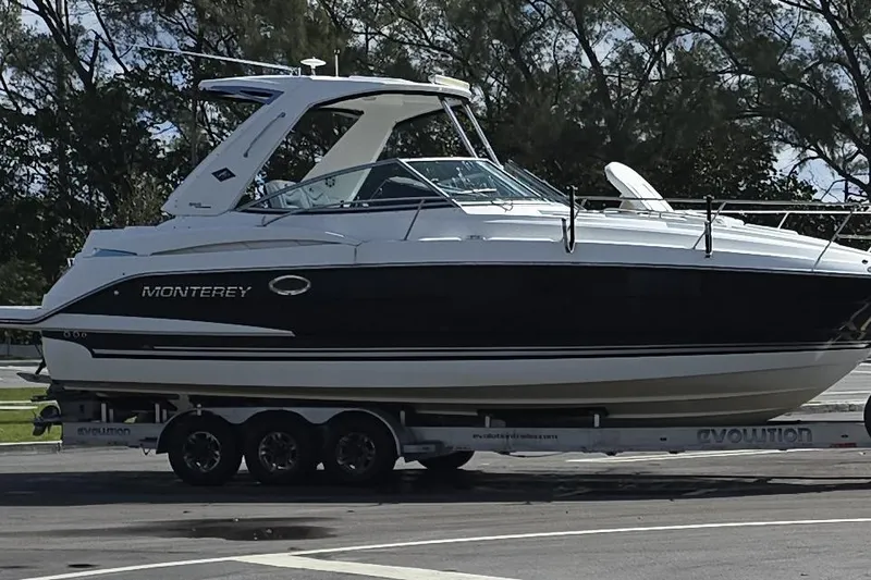 Slide: The Image of 2017 Monterey 355 Sport Yacht on trailer, parked outdoors. - 18
