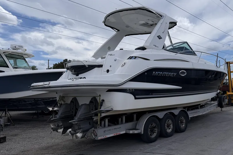 Slide: The Image of 2017 Monterey 355 Sport Yacht on trailer, showcasing sleek design and dual engines. - 19