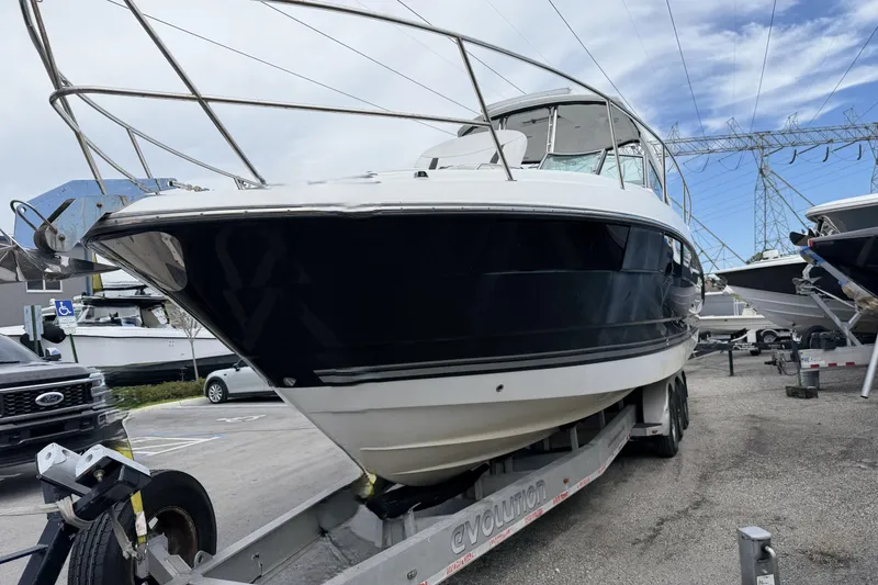 Slide: The Image of 2017 Monterey 355 Sport Yacht on trailer, parked outdoors under a cloudy sky. - 22