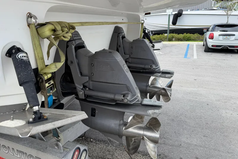 Slide: The Image of Rear view of 2017 Monterey 355 Sport Yacht with dual propellers in a parking area. - 23