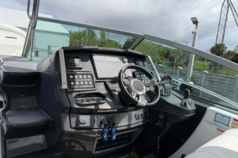 Slide: The Image of Cockpit of 2017 Monterey 355 Sport Yacht with steering wheel and control panel. - 28