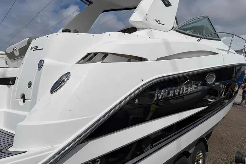 Slide: The Image of 2017 Monterey 355 Sport Yacht, sleek design, white exterior, docked under cloudy sky. - 32
