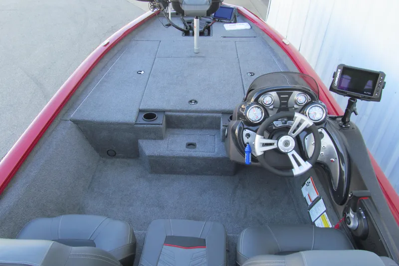Slide: The Image of 2024 Tracker Pro Team 190 TX boat interior with steering console and seating. - 5